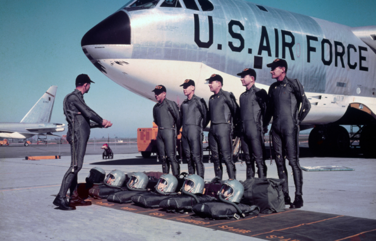 Ground crew performs maintenance on a giant Boeing B-52 stratofortress. 