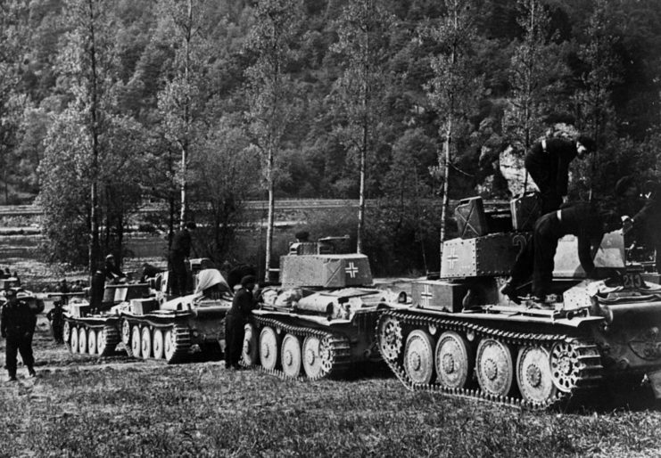 A column of tanks with the 7th Panzer Division being inspected by soldiers