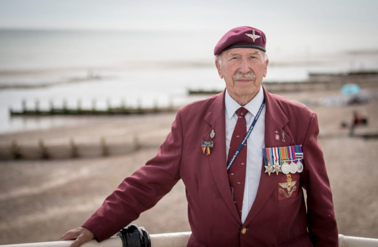 Veteran Tom Schaffer standing in front of the beach