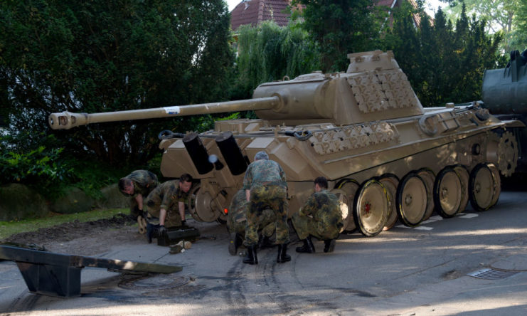 Five German soldiers preparing the 1943 Panther tank for loading