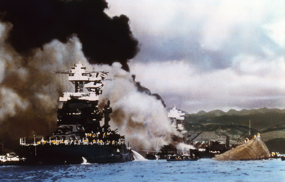 USS Maryland (BB-46) afloat beside a capsized USS Oklahoma (BB-37)