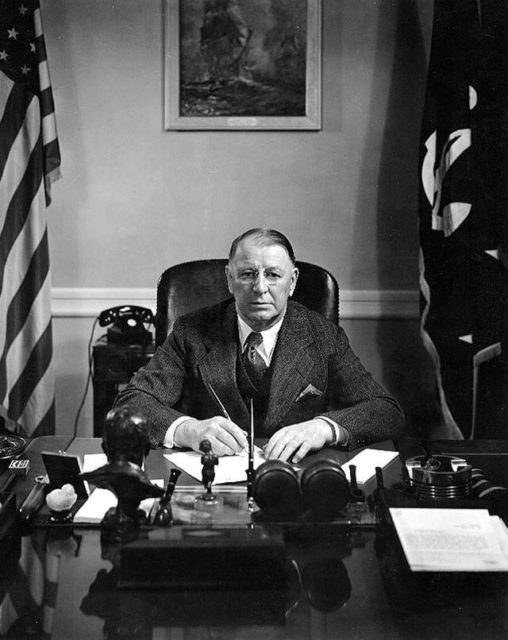 Secretary of the Navy Frank Knox sitting at his desk