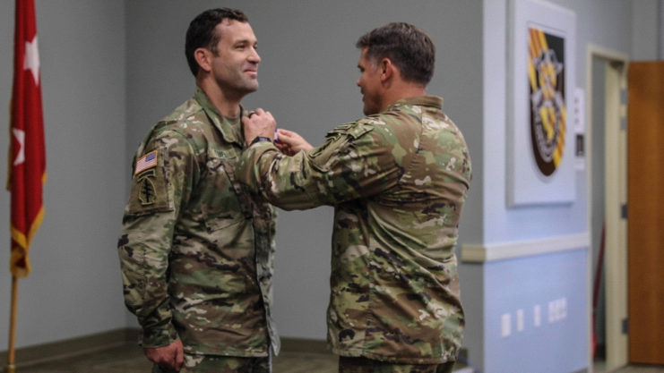 Maj. Gen. Brennan pinning the Soldier's Medal to Staff Sgt. Tyrrel's chest