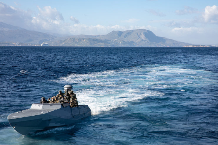 Members of the Navy Special Warfare combatant-crew on a motorboat at sea