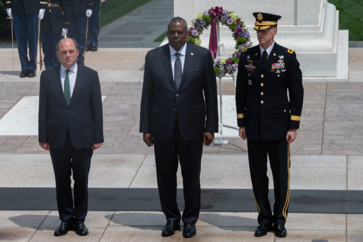 Ben Wallace, Lloyd J. Austin II and Allan Pepin standing at attention in front of a wreath