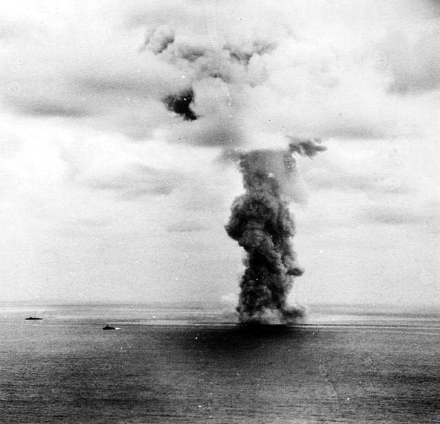 A cloud of smoke emanating from the Yamato while its in the ocean
