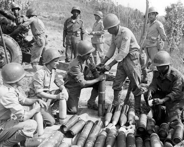 Brazilian troops sitting among ammunition along the Gothic Line
