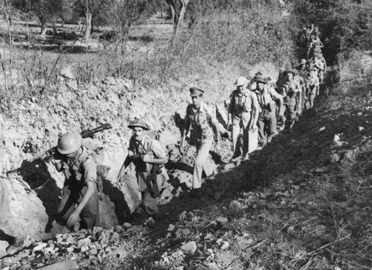 Eighth Army troops walking in a trench along the Gothic Line