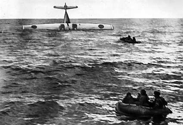 Lifeboats and a downed airplane in the ocean