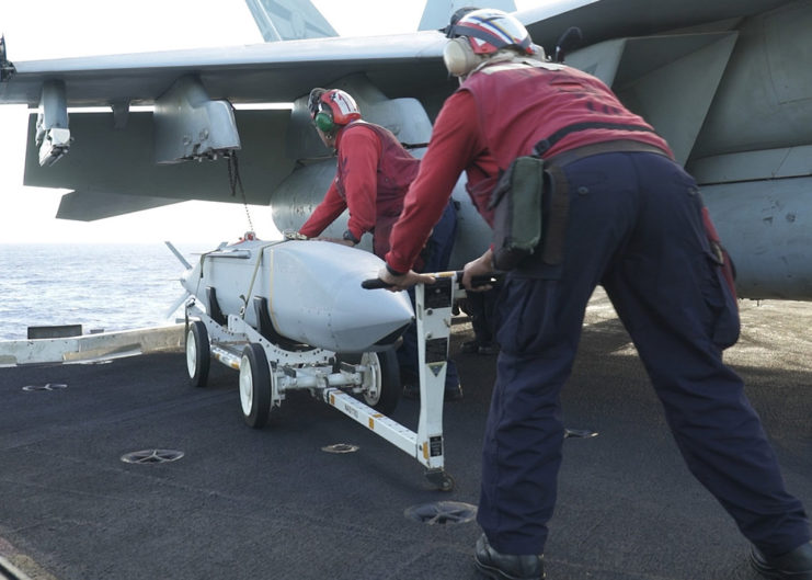 Sailors prepare to load ordnance on the USS Carl Vinson