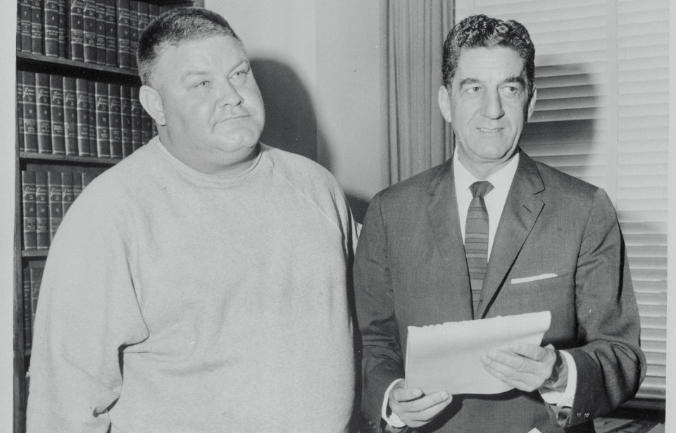 Ferdinand Waldo Demara (left) referred to in the past as the "Great Imposter" is shown with Deputy D.A. Manley Bowler May 8 after he surrendered himself upon learning he had been charged with grand theft auto.