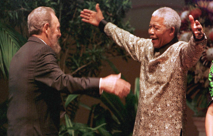 South African President Nelson Mandela (R) greets Cuban leader Fidel Castro as he arrives for the opening of the 12th Non-Aligned Movement summit in Durban on September 2, 1998.