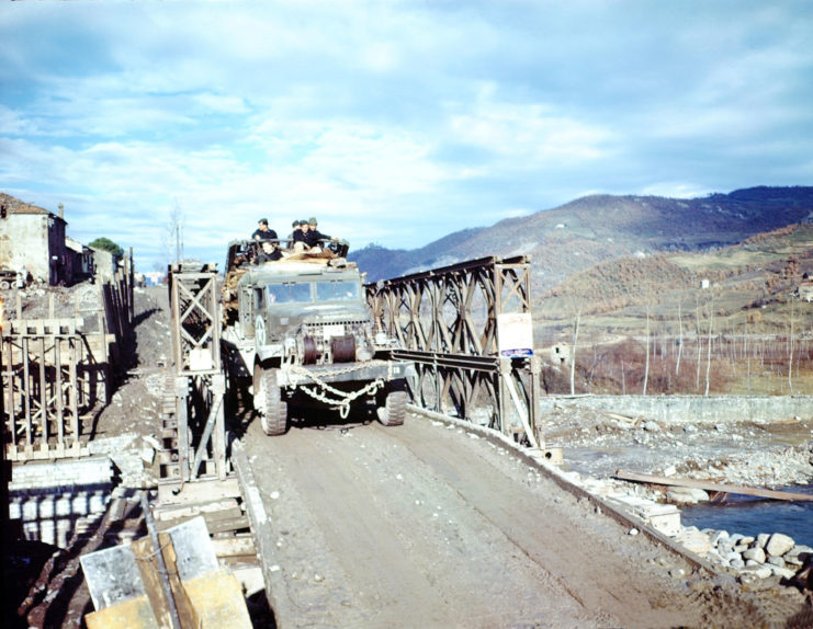 Military vehicle crossing the bridge at Rio Maggiore with troops aboard
