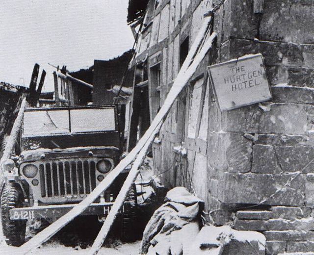 Jeep parked outside a derelict building