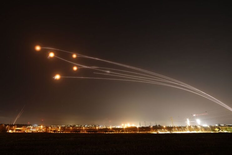 Iron Dome intercepting rockets over an Israeli city at night