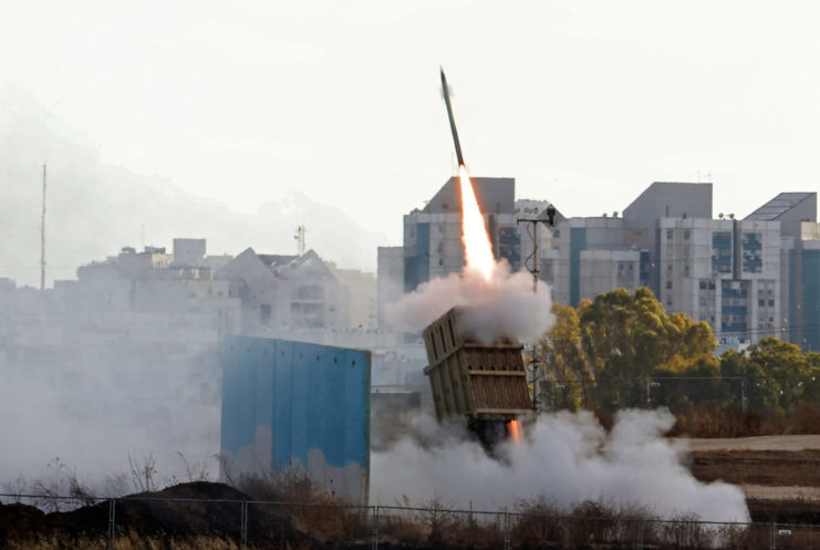 Tamir interceptor missile being fired from a mobile launcher in the middle of an urban area
