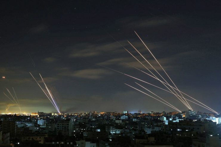 Iron Dome intercepting rockets over an Israeli city at night