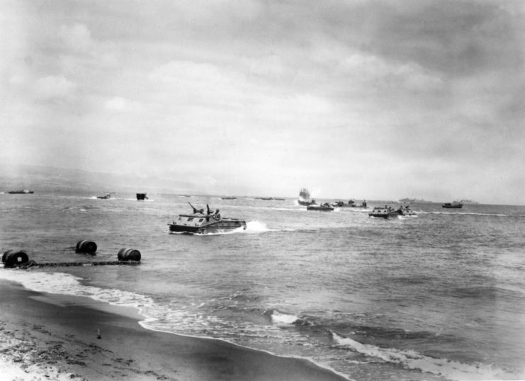Landing Vehicles, Tracked (LVTs) driving through the ocean, toward Guadalcanal Beach