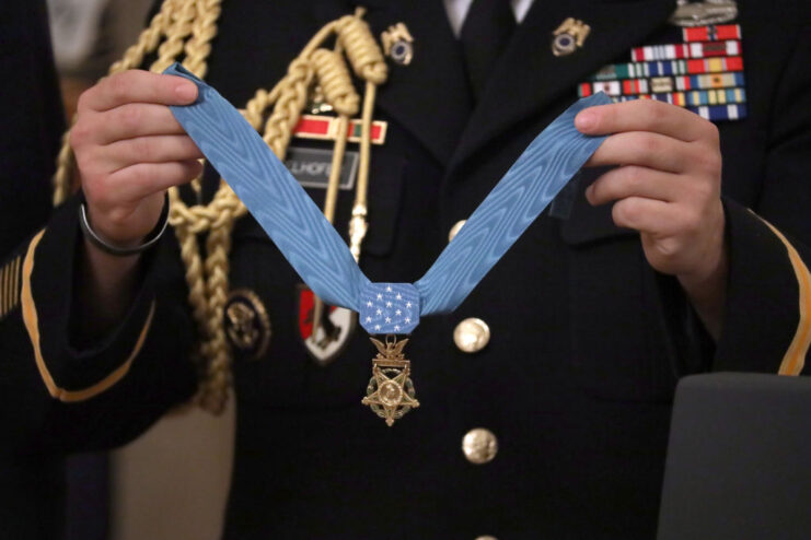 US military aide holding the Medal of Honor