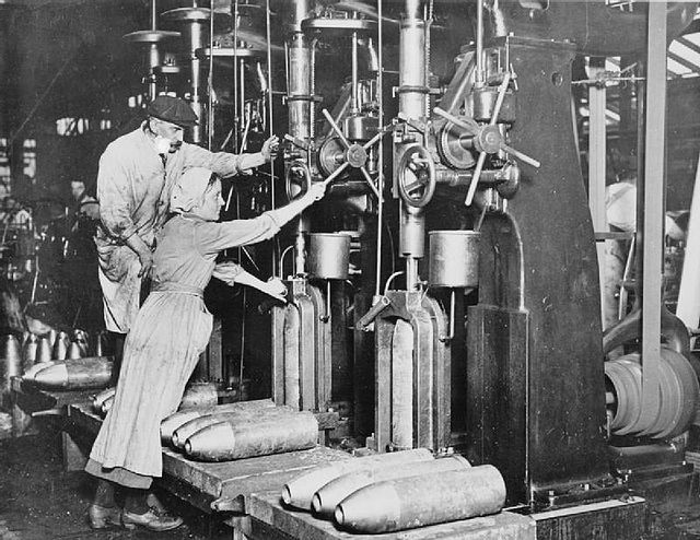 Female and male workers manning a machine together