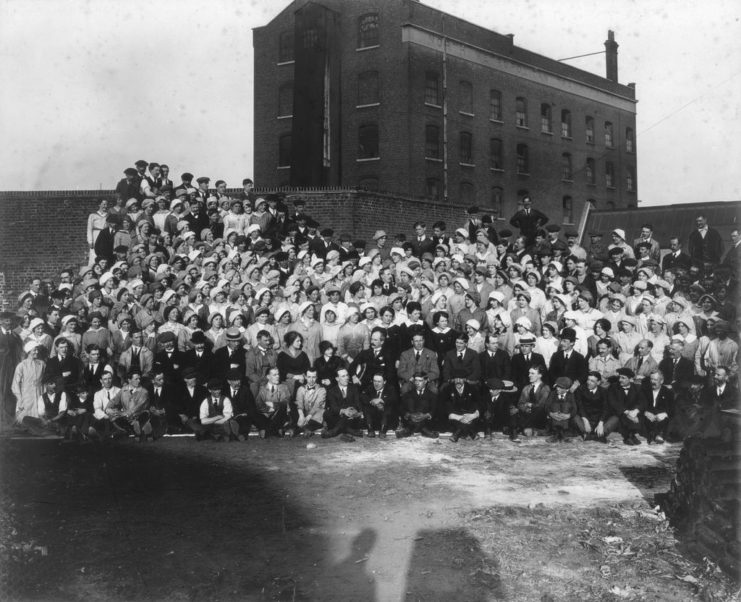 Munitions workers standing outside of a factory