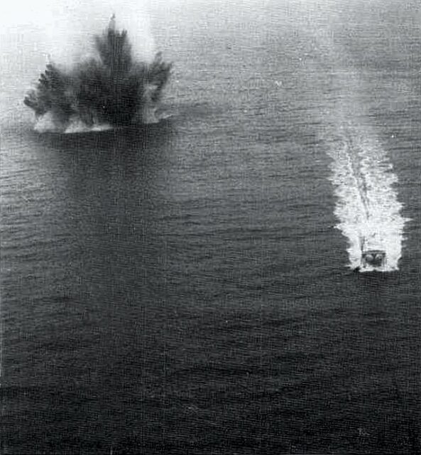 Ship transiting past an exploding sea mine off the coast of Haiphong, Vietnam