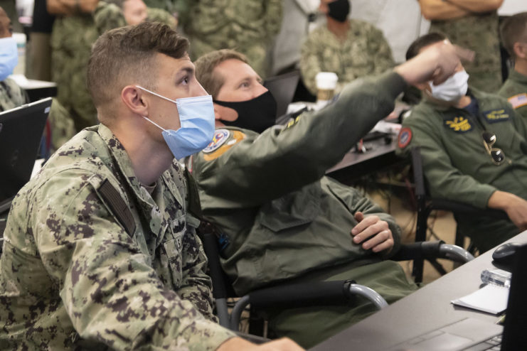 U.S. 3rd Fleet personnel staring at a screen