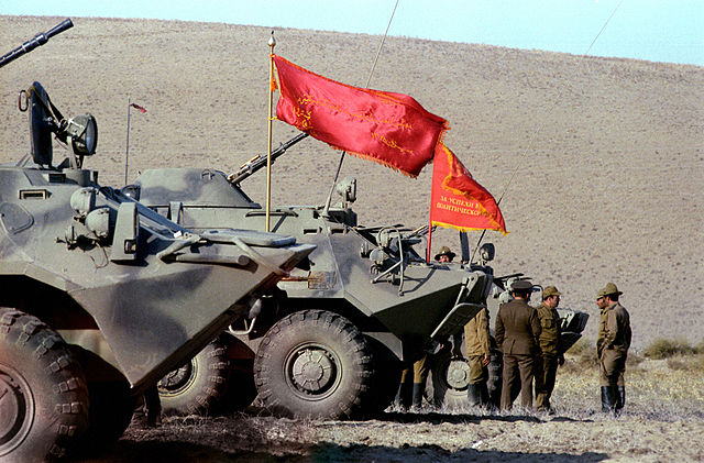 Soviet troops standing near two tanks