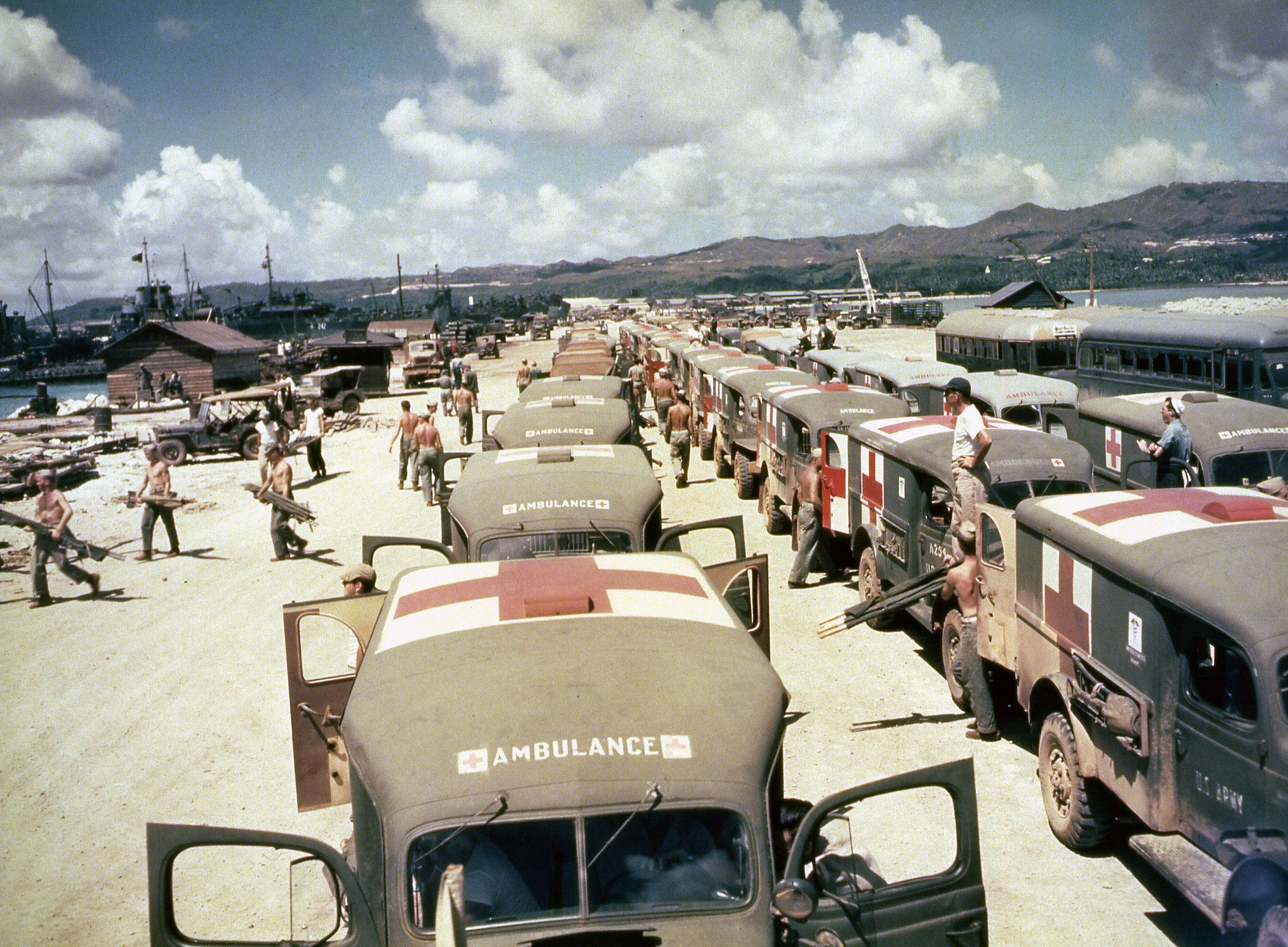View of military ambulances lined up on shore at Guam, awaiting the arrival of the USS Solace with casualties from Okinawa, June 1945. (Photo by PhotoQuest/Getty Images)
