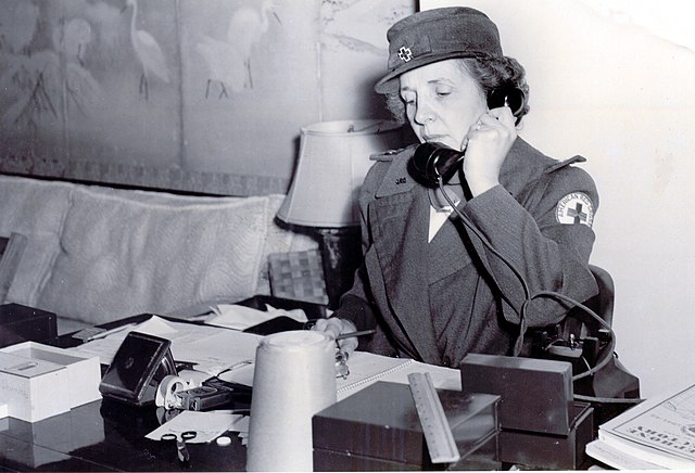 Una Walker holding a telephone up to her ear