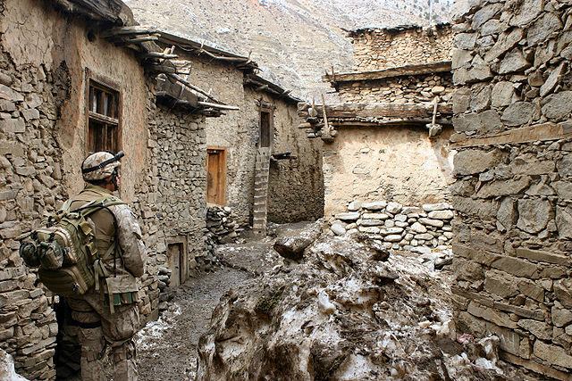 American solider walking through an Afghan city