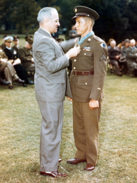During a ceremony on the White House lawn, American politician US President Harry S Truman (1884 - 1972) presents the Medal of Honor to US Army Corporal Clarence B Craft (1921 - 2002).