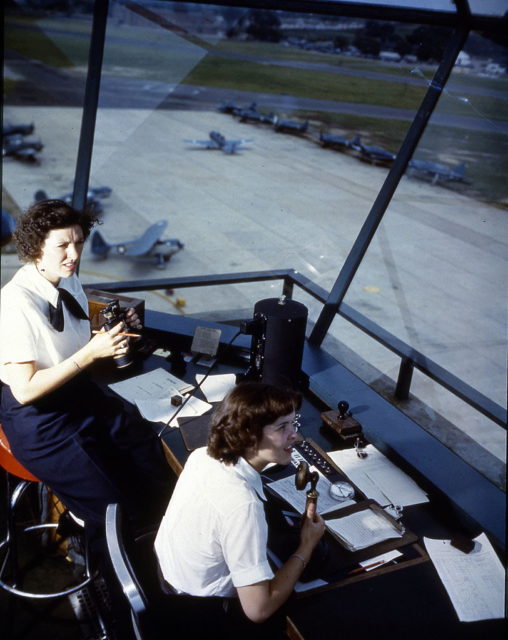 Overhead view of Dorothy Knee and Genevieve Close working in an air traffic control tower