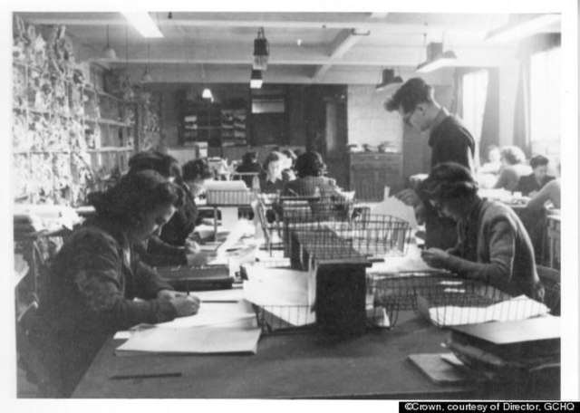 Women writing on paper at a table