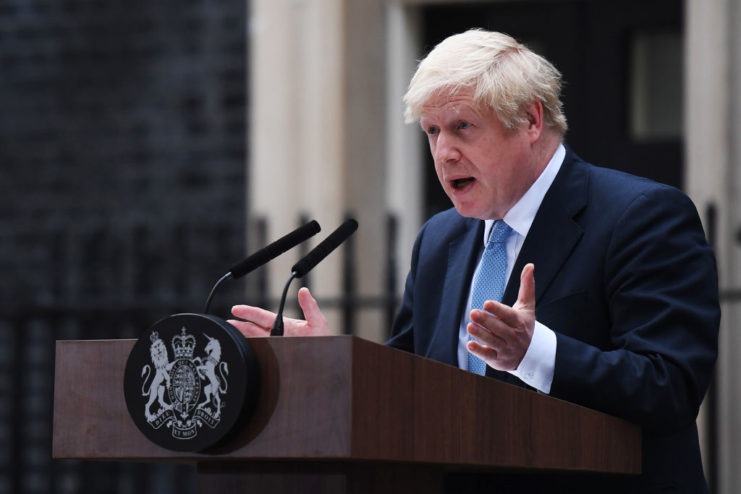 UK Prime Minister Boris Johnson speaking behind a podium