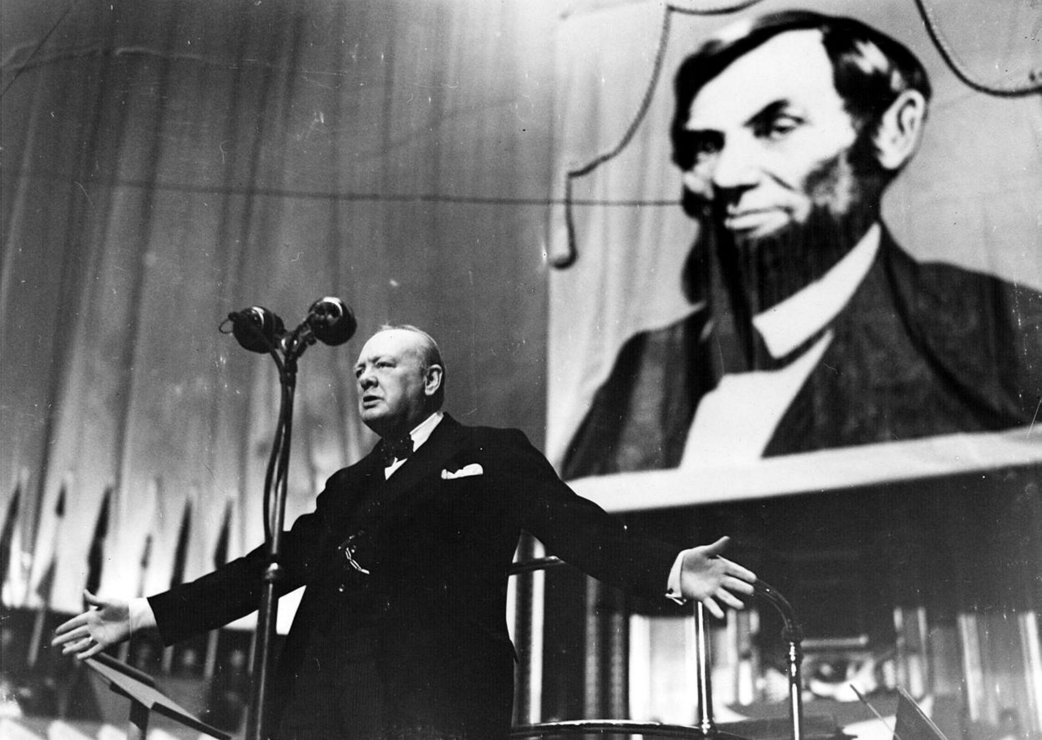 Photograph of Winston Churchill (1874-1965) speaking at the Albert Hall in front of a large picture of Abraham Lincoln (1809-1865). Dated 1944 (Photo by: Universal History Archive/UIG via Getty images)