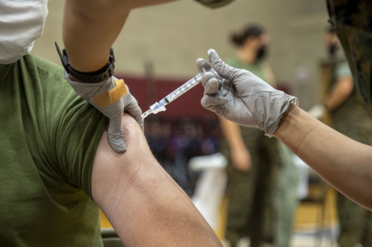 Vaccination needle in a soldier's arm