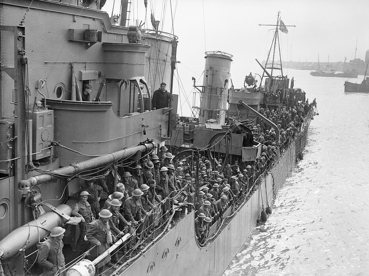 Troops evacuated from Dunkirk on a destroyer about to berth at Dover, 31 May 1940. Evacuated troops on a destroyer about to berth at Dover, 31 May 1940.  (Photo Credit: Public Domain)