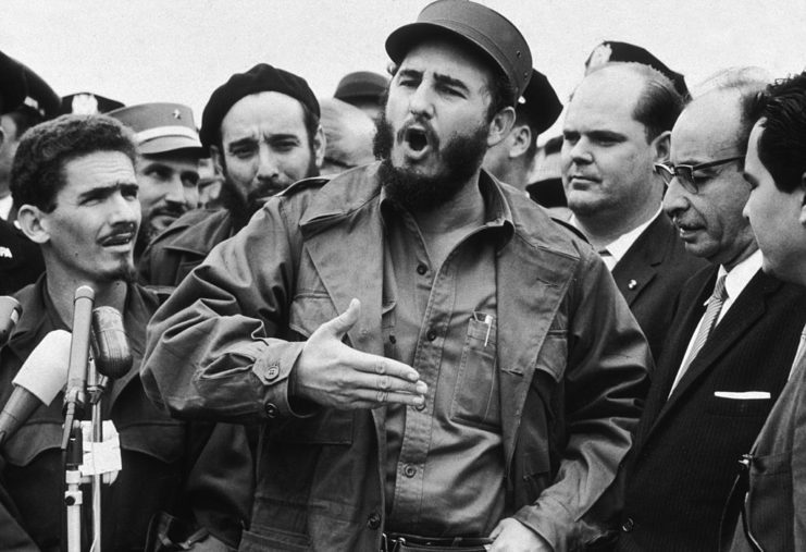 Group of men watching Fidel Castro speak