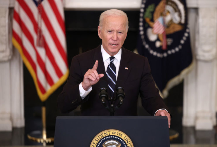 US President Joe Biden standing behind the presidential podium