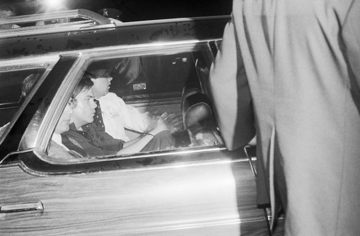 John Hinckley Jr. sitting in the back of a car