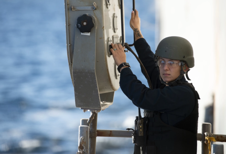 Female Navy personnel standing behind a LRAD