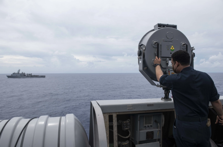 Man standing behind a LRAD