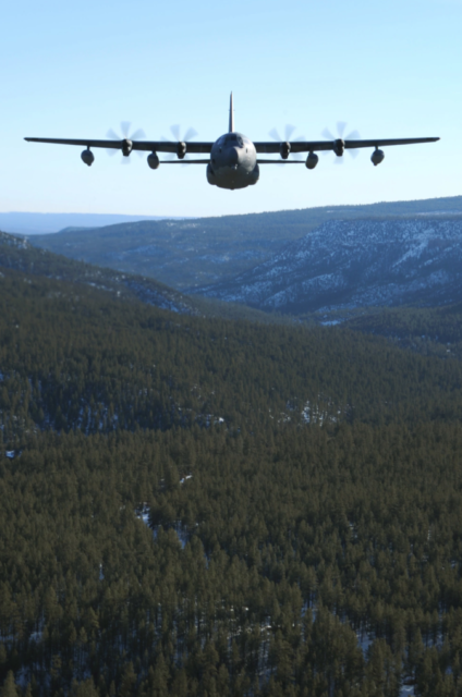 MC-130J Commando II flying above a forest