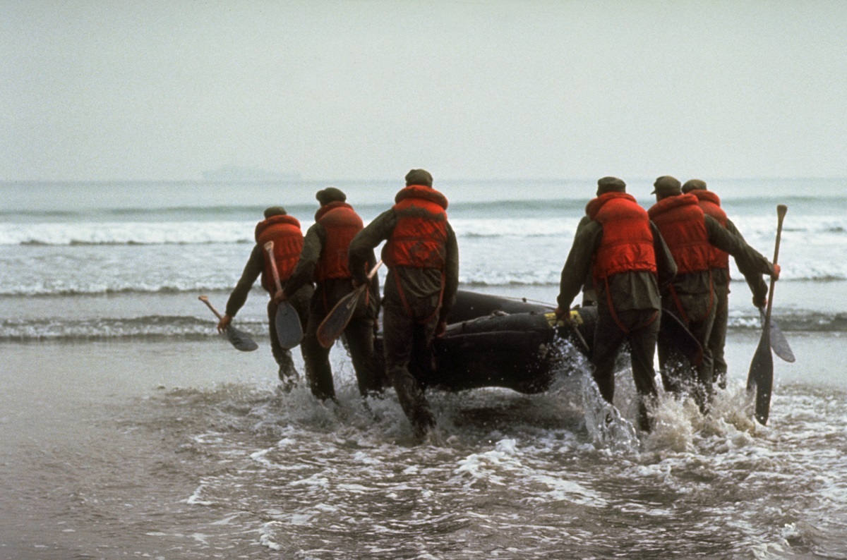 U.S. Navy Basic Underwater Demolition/Sea-Air/Land (SEAL) (BUD/S) trainees launch a rubber boat into the surf during a 