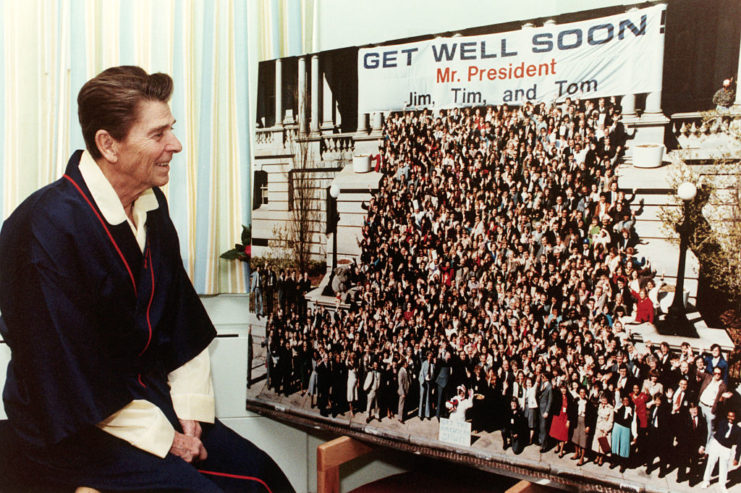 Ronald Reagan staring at a get well card