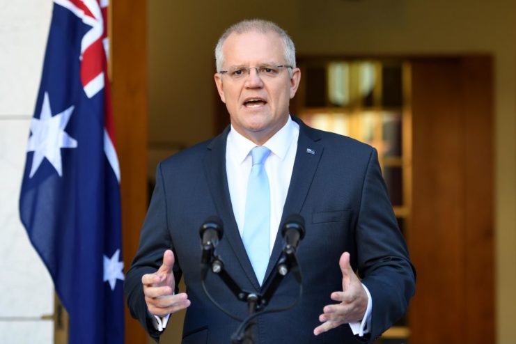 Australian Prime Minister Scott Morrison speaking behind a podium