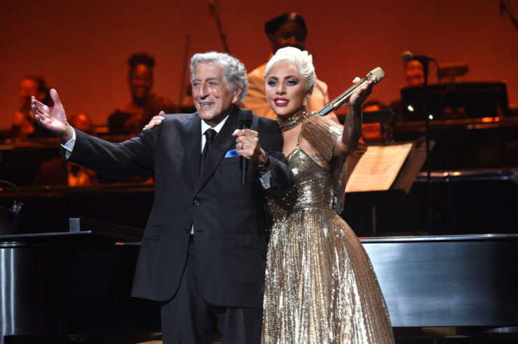 Tony Bennett standing on stage with Lady Gaga
