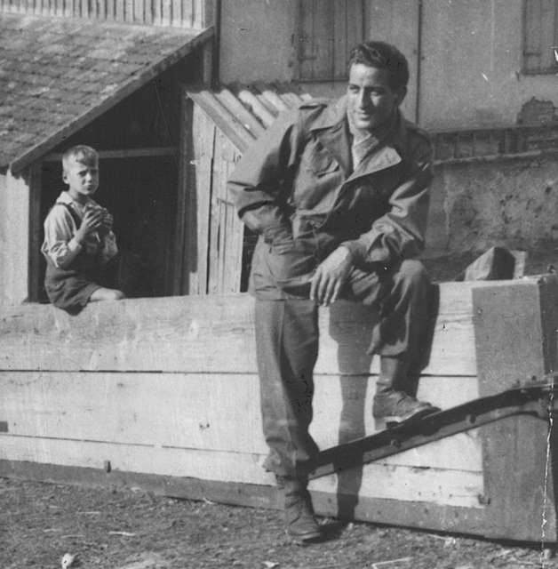 Tony Bennett leaning against a cement wall, with a young boy looking at him