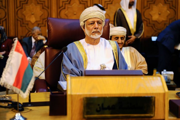 Yusuf bin Alawi bin Abdullah standing behind a podium